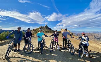 Group shot standing with the bikes on top of the Backbone Trail, Malibu, California, USA. CC:LifeRush Adventures