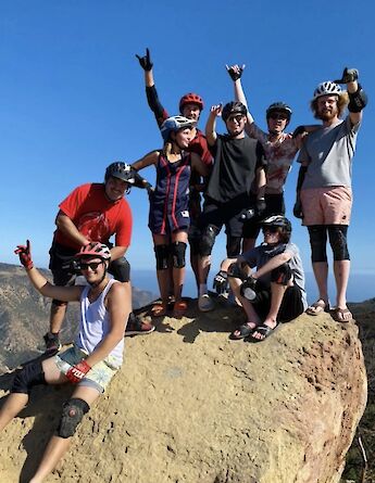 Hands in the air on top of a rock, Malibu, California, USA. CC:LifeRush Adventures