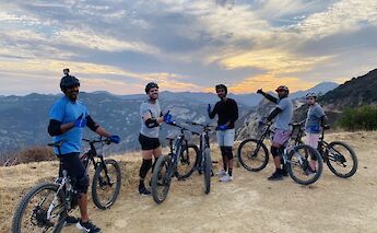 Group photo on top of the ridge at dusk, Malibu, California, USA. CC:LifeRush Adventures