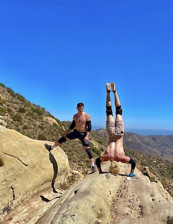 Doing a headstand on a butte, Malibu, California, USA. CC:LifeRush Adventures