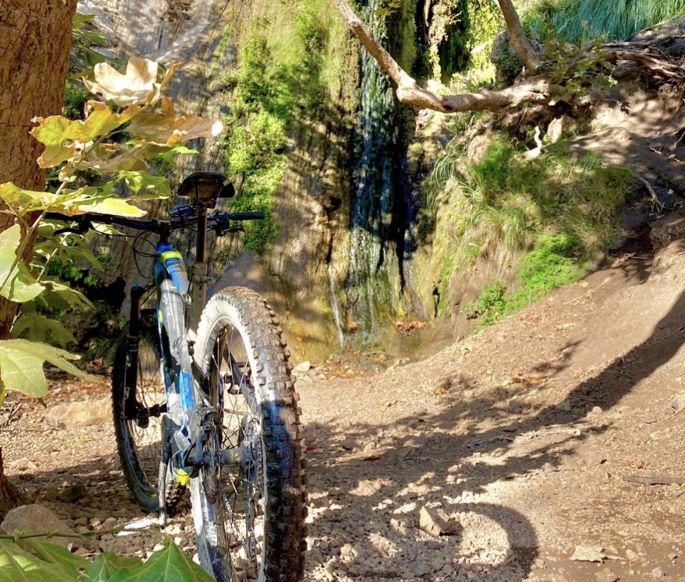 A mountain bike parked near the waterfall, Malibu, California, USA. CC:LifeRush Adventures