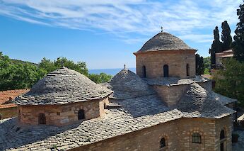 The Monastery of Evangelistria on Skiathos, Greece, with its distinctive stone domes and scenic backdrop.
