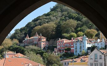 Houses viewed through an archway in Sintra, Portugal bike tours. Hongbin@Unsplash