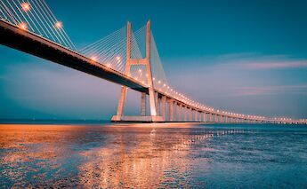 Vasco da Gama Bridge at sunset, Lisbon, Portugal bike tours. Getty Images@Unsplash