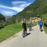 Cycling through a village, Voss, Norway. CC:Outdoor Norway