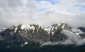 Clouds over snow-capped mountains, Voss, Norway. Barnabas Davoti@Unsplash