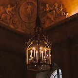 Chandelier at night in Versailles, Paris, France. Mathias Reding@Unsplash