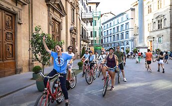 Bike tour guide leading the group through Florence, Italy. CC:TO