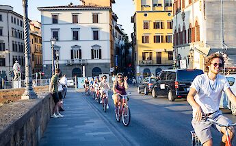 Bike tour over a bridge in Florence, Italy. CC:TO