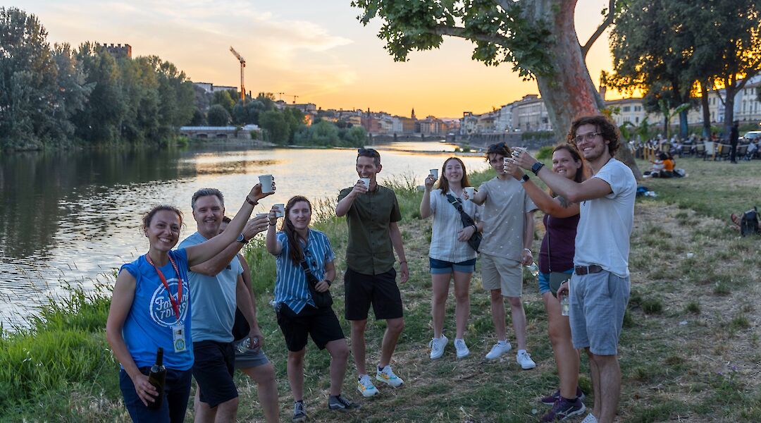 Enjoying wine on the banks of the river, Florence, Italy. CC:TO