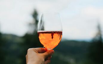 Holding a glass of Tuscan wine. Getty Images@Unsplash