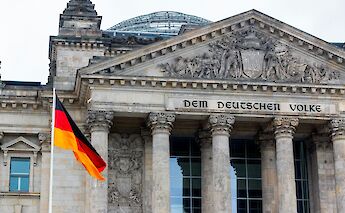 German flag outside the Reichstag, Berlin, Germany. Rasmus Gundorff Saed@Unsplash