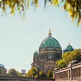 Museum Island viewed through foliage, Berlin, Germany. Julia Solonina@Unsplash