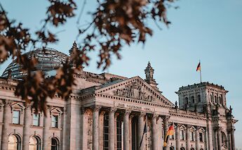 The Reichstag viewed through foliage, Berlin, Germany. Yannic Kress