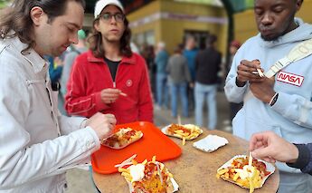 Tasting currywurst on the Berlin bike tour, Germany. CC:TO