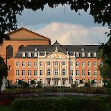 Electoral Palace viewed through foliage, Trier, Germany. Unsplash:Hongbin