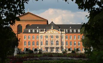 Electoral Palace viewed through foliage, Trier, Germany. Unsplash:Hongbin