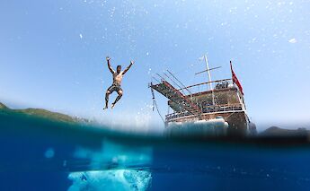 Man jumping off the boat, Leros Island, Greece. CC:Island Hopping