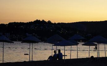 Couple on the beach at sunset in Bodrum, Turkey. Unsplash:Hussein A Himmati
