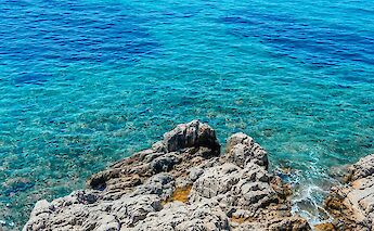 A rocky shoreline with clear blue water in Bodrum, Turkey.