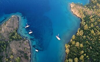 Aerial view of a bay in Bodrum with boats and turquoise water.
