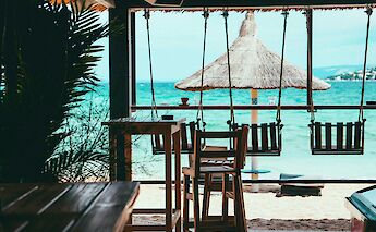 Swinging chairs in a cafe on Pag, Croatia. Unsplash:Kat Von Wood