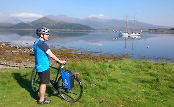 Cyclist admiring the landscape, Scotland. CC:Island Hopping