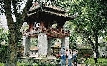 Tourists looking at a temple, Hanoi, Vietnam. Unsplash:JM Eserjose