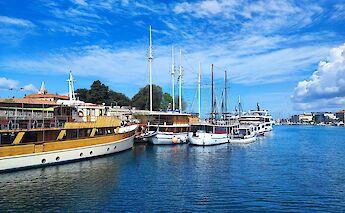 Boats with masts in Zadar, Croatia. Unsplash:Kristina Kutlesa