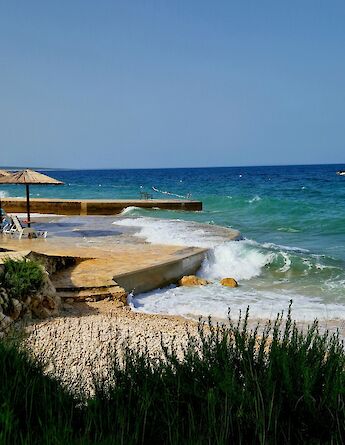 Parasols on Pag, Croatia. Unsplash:Benko Regina