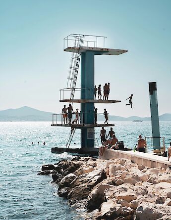 People jumping off platforms into the sea, Zadar, Croatia. Unsplash:Karl Paul Baldacchino