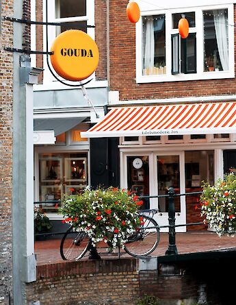 Bicycle parked by a Gouda cheese shop, Holland. Unsplash:Jessica Kantak Bailey