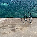 Ladder into the sea, Salina, Italy. Unsplash:Emma Dickopf