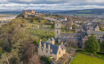 Aerial view of Stirling Castle in Scotland, with surrounding town and cemetery.