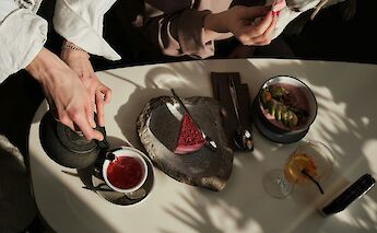 Enjoying tea and dessert. Andrej Lisakov@unsplash