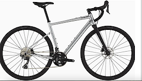 A silver gravel bike with modern features, including drop handlebars and disc brakes, highlighting a minimalist design.