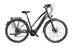 A black electric touring bike with a step-through frame, equipped with a rear rack and disc brakes, designed for comfortable rides.