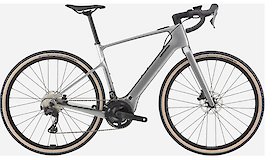 A sleek silver electric gravel bike with a modern design, featuring black handlebars and tires with a light tan sidewall.