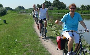 Canal side cycling in the Dutch countryside. to-BBT