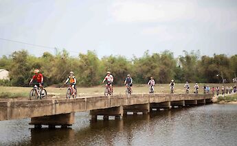 Riders crossing a rural bridge. toMBS