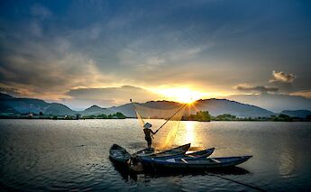 Fishing boats at sunrise. quang nguyen vinh@pexels