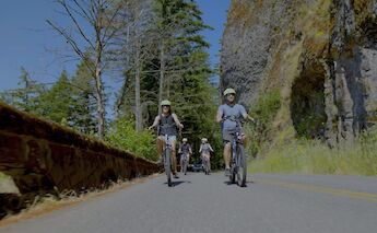Biking past basalt, Multnomah Falls, Oregon, USA. CC:Ebike Multnomah Falls