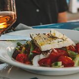 Greek salad with wine. unsplash@LoesKlinker