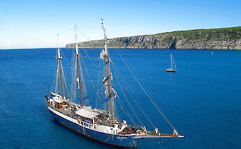 The tall ship, Atlantis, anchored along the Tuscan coast. c-toIH