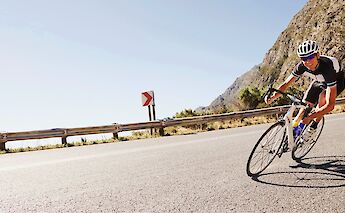 Riding down a mountain road on a road bike. Getty Images@Unsplash