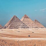 The pyramids standing against the vast Sahara Desert. AbdelrhamAllam@unsplash