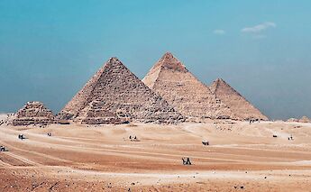 The pyramids standing against the vast Sahara Desert. AbdelrhamAllam@unsplash
