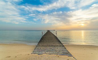 A pier stretching into the calm Red Sea. SandroGautier@unsplash