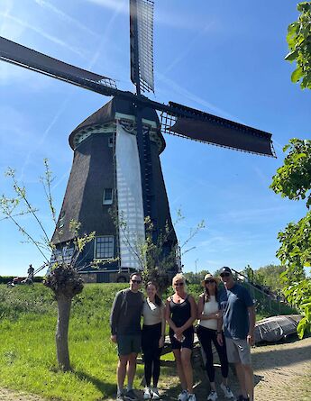Bike tour group by a windmill, Amsterdam e-bike tour. CC:TO