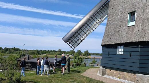 Bike tour next to a windmill at Zaanse Schans, Amsterdam e-bike tour. CC:TO